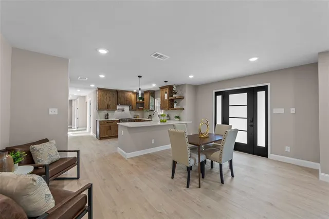 a dining room with furniture and wooden floor