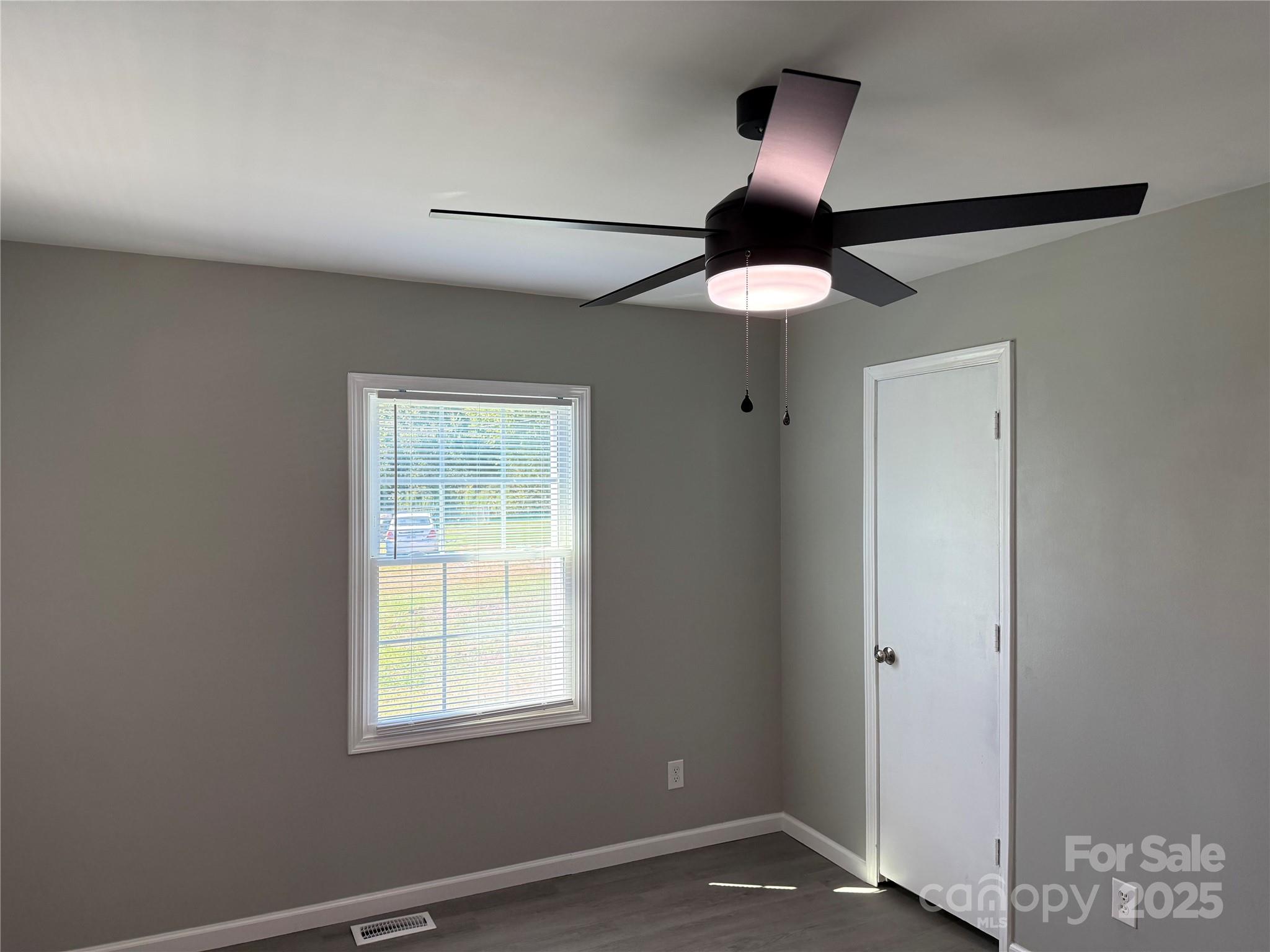 837 Sikes Mill Road Monroe, NC 28110 - Photo 11 of 16 a view of an empty room with window and chandelier fan