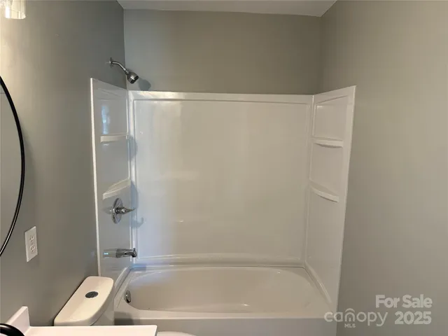 a bathroom with a tub and a shower