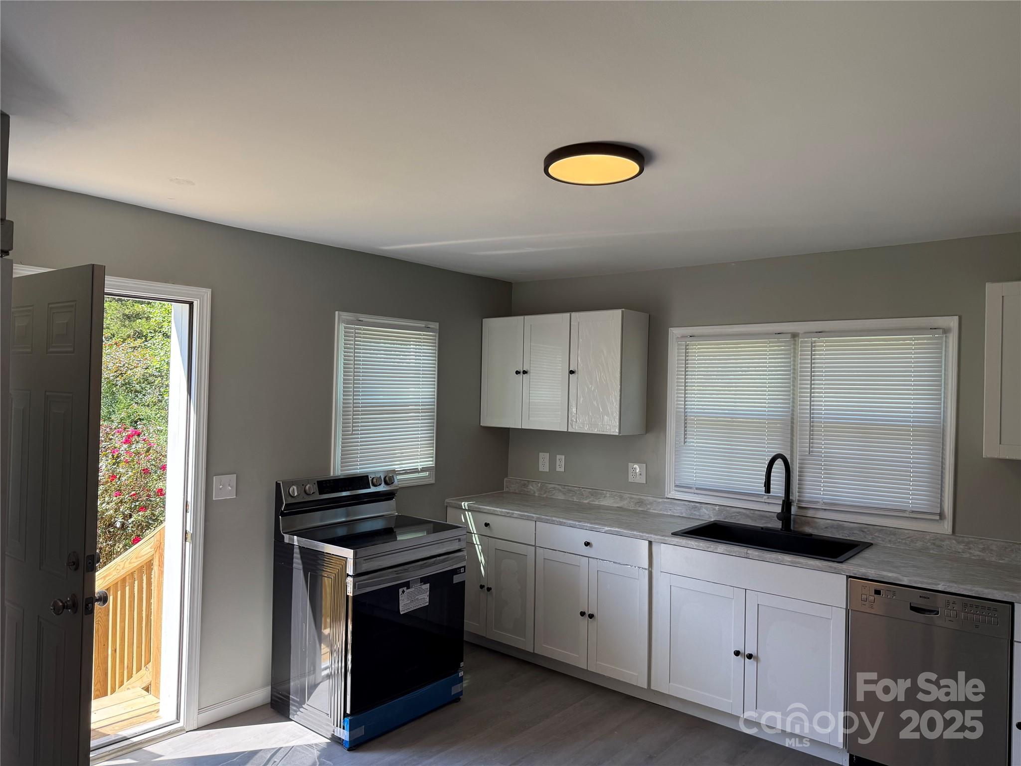 837 Sikes Mill Road Monroe, NC 28110 - Photo 16 of 16 a kitchen with granite countertop a sink a stove and cabinets