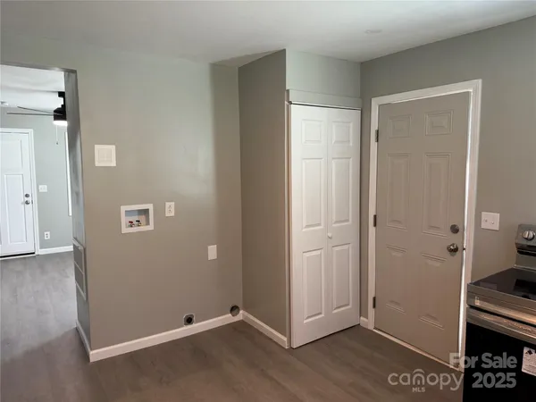 an empty room with wooden floor and closet