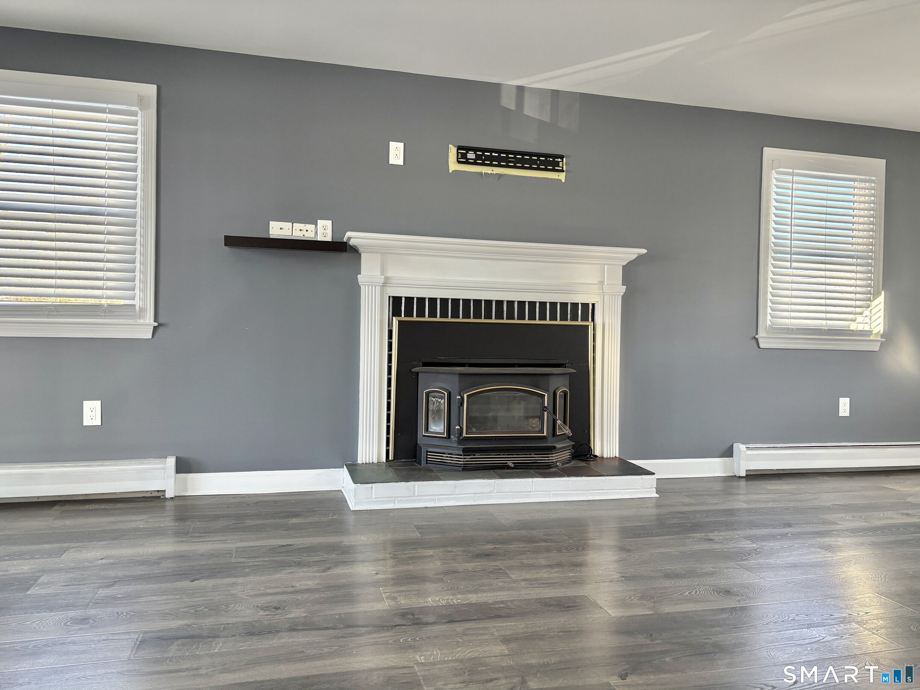 31 Pegasus Drive Groton, CT 06340 - Photo 12 of 17 a view of empty room with wooden floor and fireplace