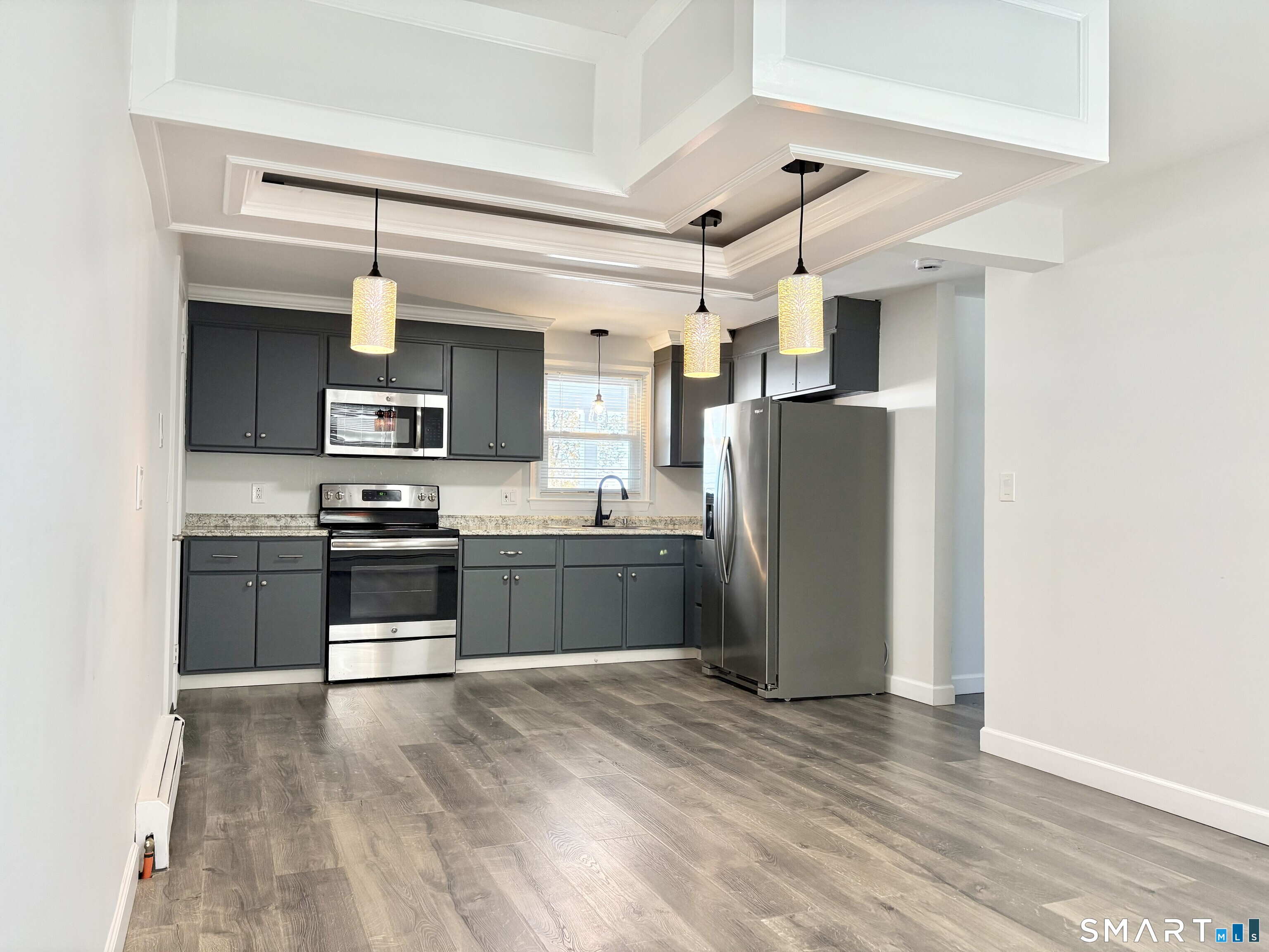31 Pegasus Drive Groton, CT 06340 - Photo 5 of 17 a kitchen with stainless steel appliances a refrigerator and a stove top oven