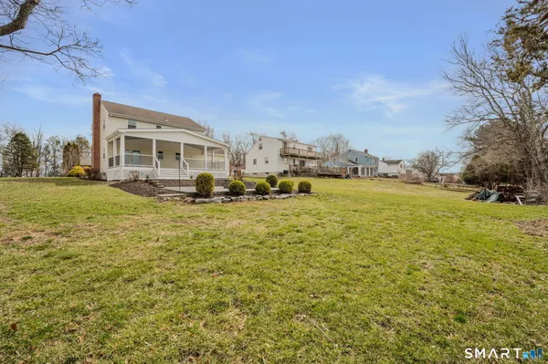 a kitchen with stainless steel appliances kitchen island granite countertop a table chairs and a refrigerator