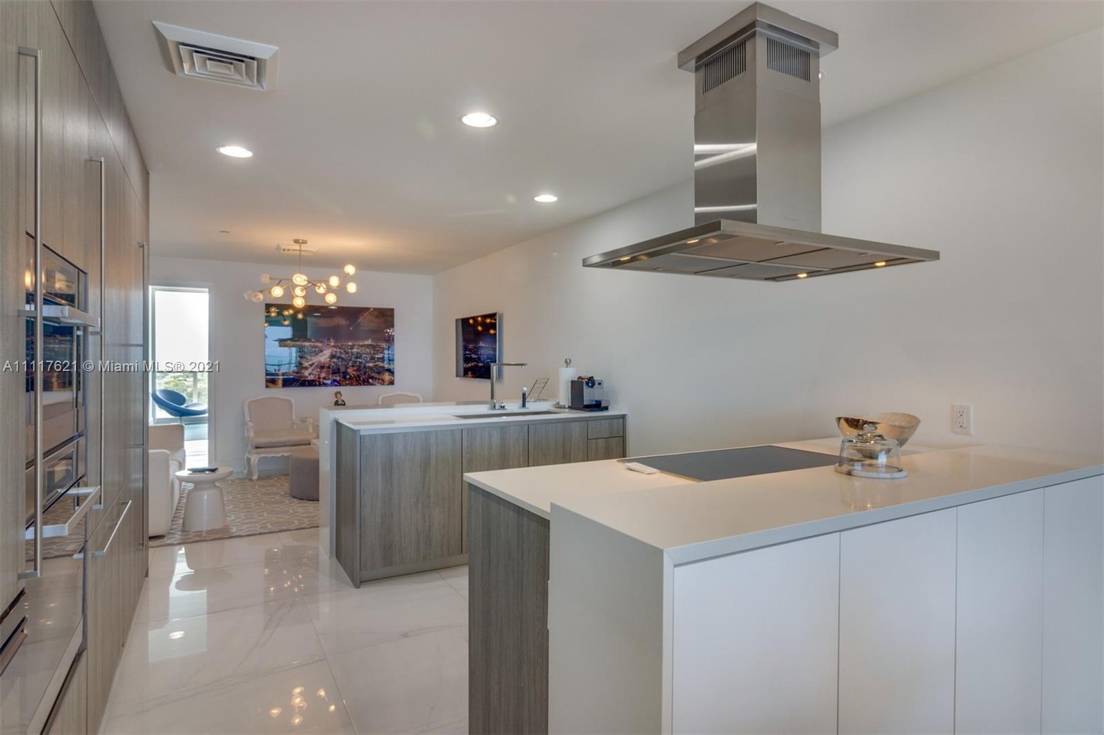 360 Ocean Drive, Unit 1106S Key Biscayne, FL 33149 - Photo 11 of 35 a kitchen with a sink a stove cabinets and refrigerator