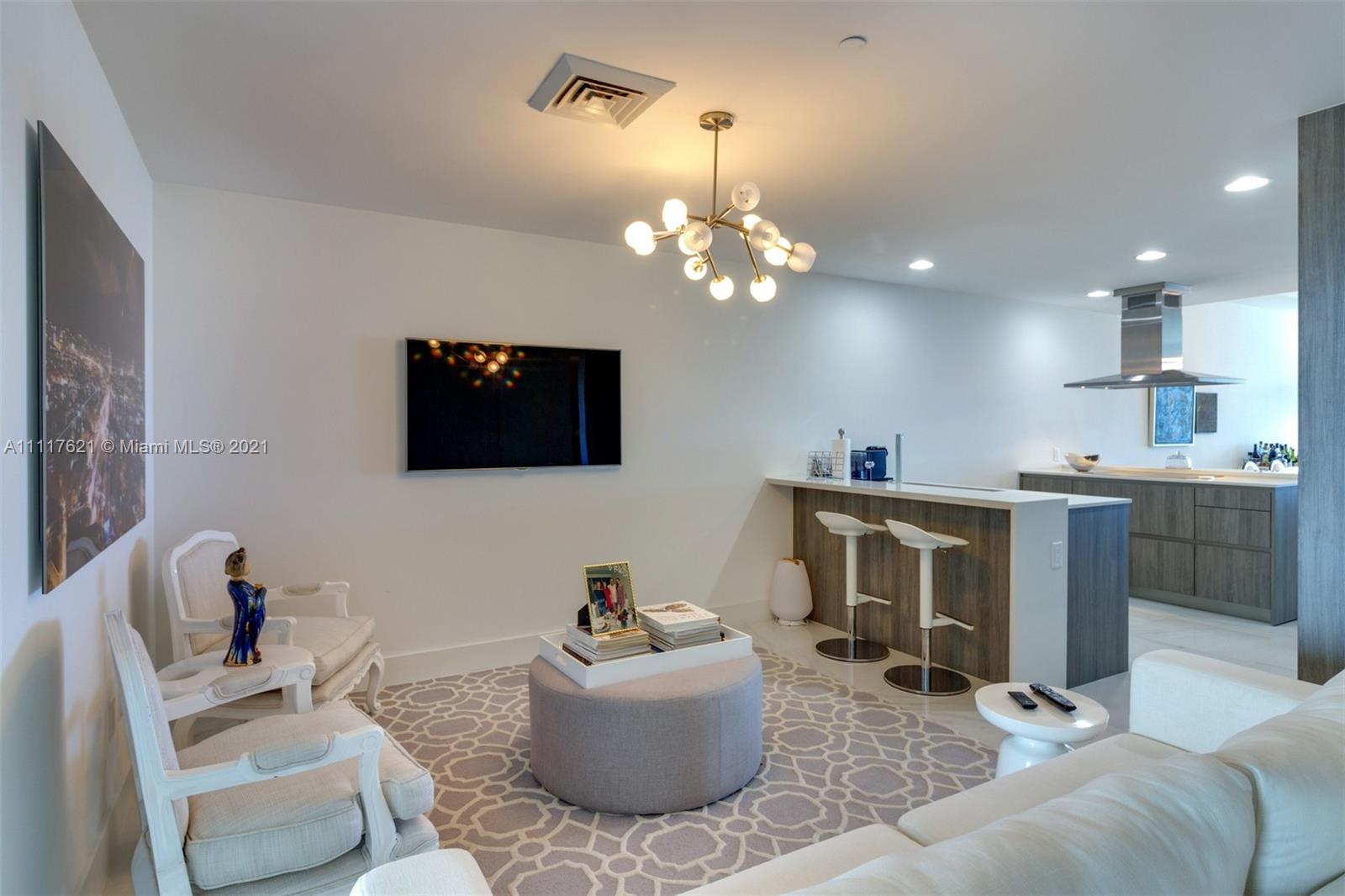 360 Ocean Drive, Unit 1106S Key Biscayne, FL 33149 - Photo 13 of 35 a living room with furniture and a flat screen tv