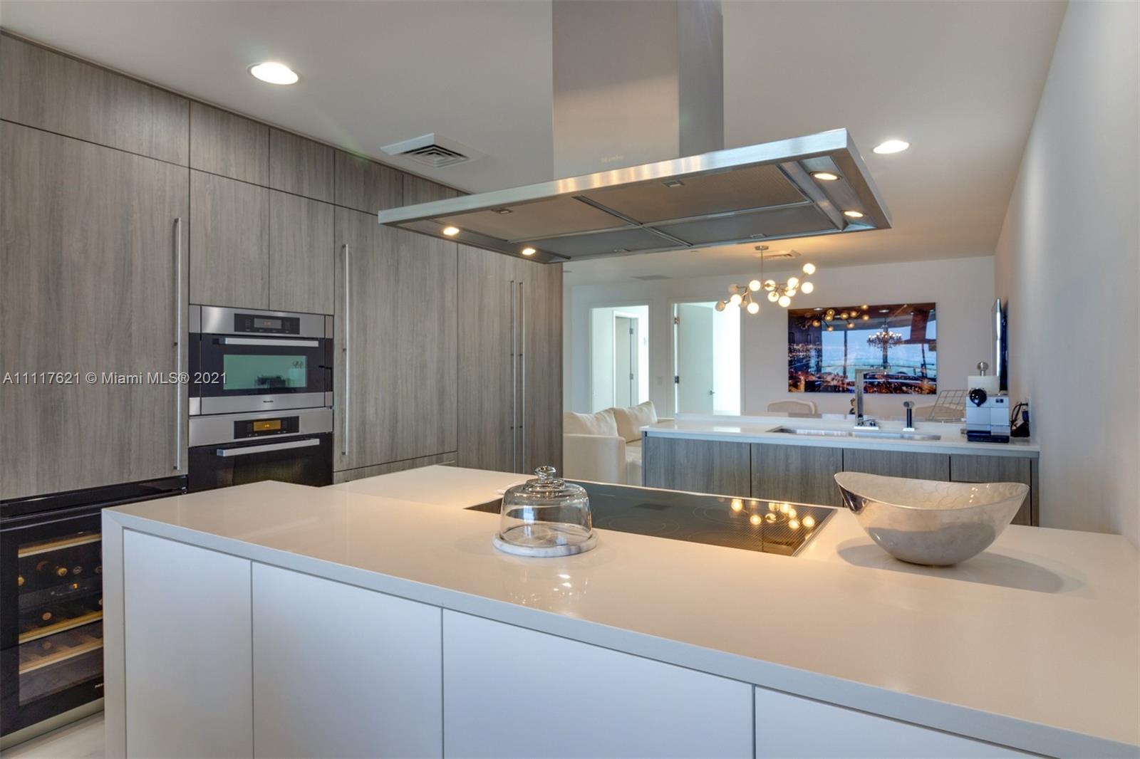 360 Ocean Drive, Unit 1106S Key Biscayne, FL 33149 - Photo 14 of 35 a kitchen with kitchen island a sink stainless steel appliances and cabinets