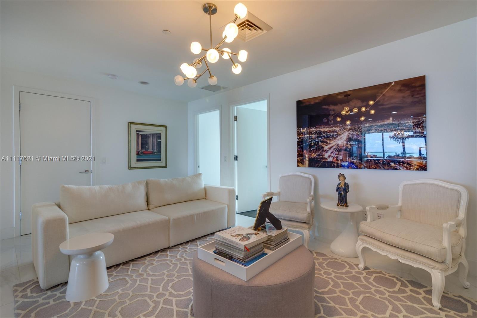 360 Ocean Drive, Unit 1106S Key Biscayne, FL 33149 - Photo 15 of 35 a living room with furniture and a chandelier