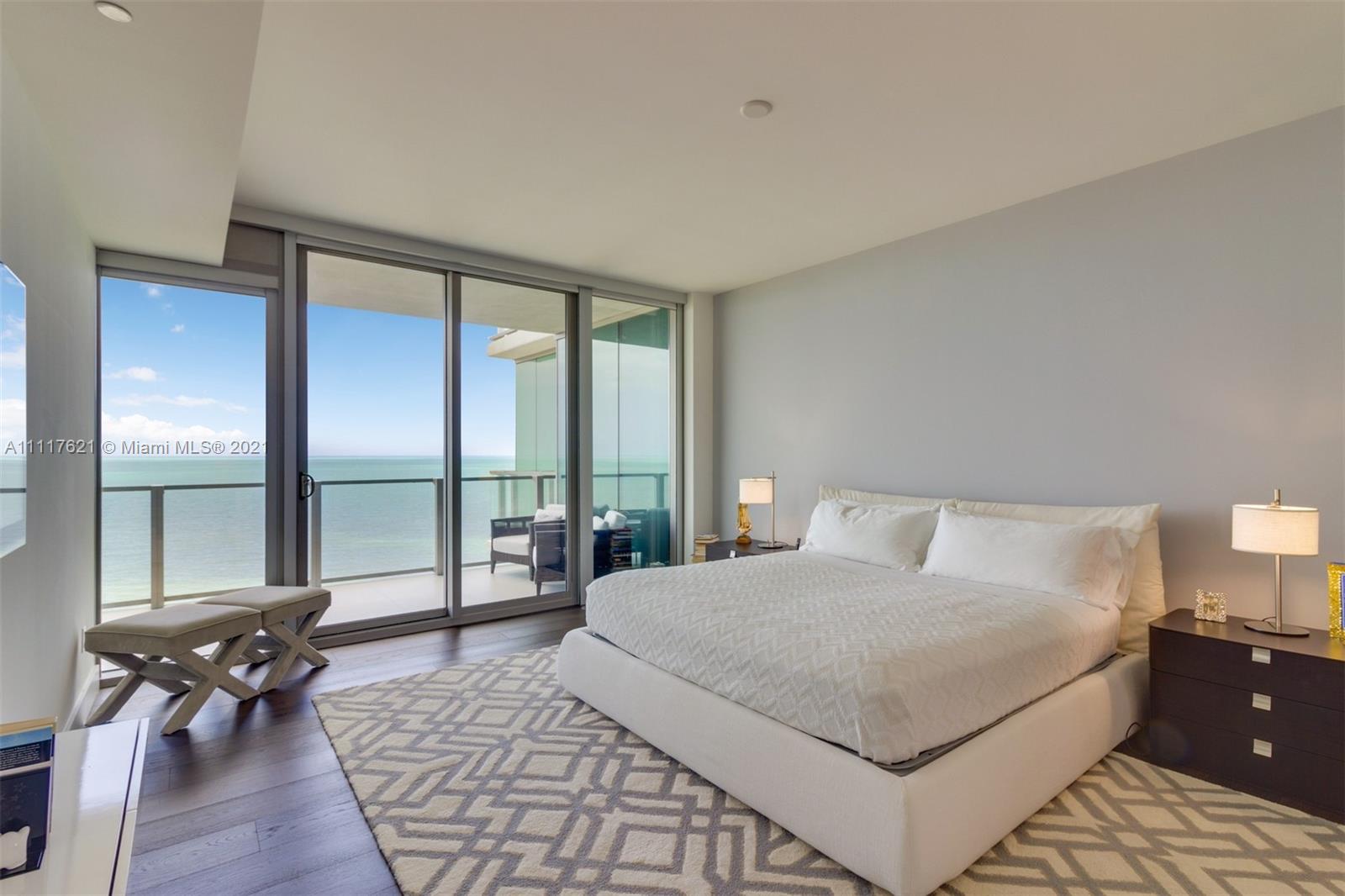 360 Ocean Drive, Unit 1106S Key Biscayne, FL 33149 - Photo 16 of 35 a bedroom with a large bed and a large window