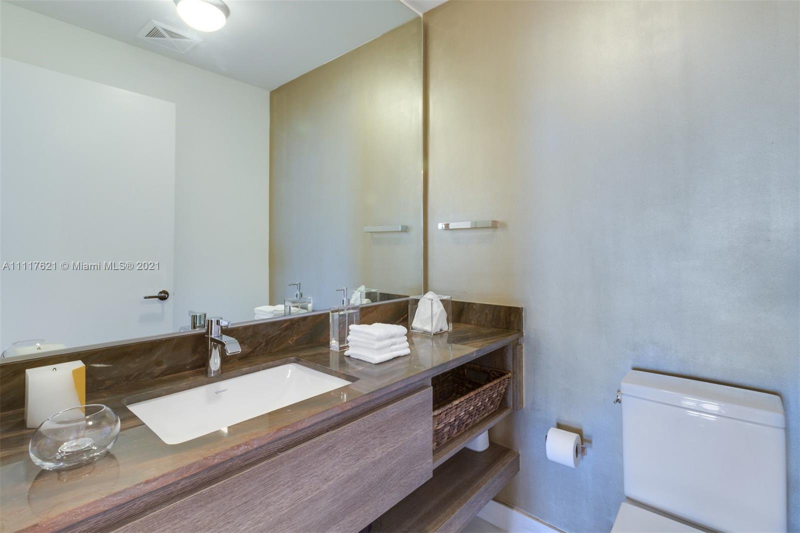 360 Ocean Drive, Unit 1106S Key Biscayne, FL 33149 - Photo 23 of 35 a bathroom with a sink and a mirror