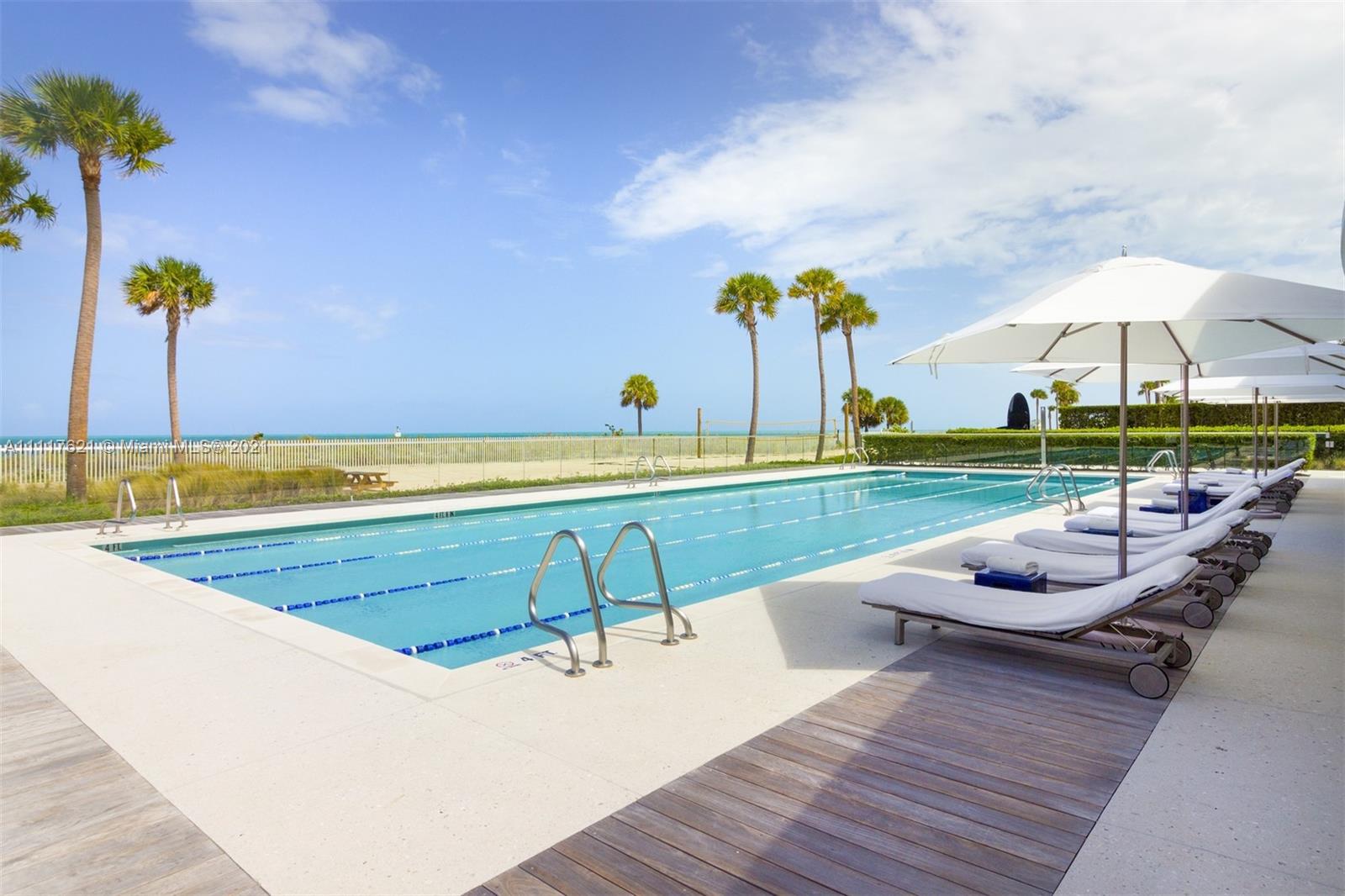 360 Ocean Drive, Unit 1106S Key Biscayne, FL 33149 - Photo 34 of 35 a view of a swimming pool with a lounge chair
