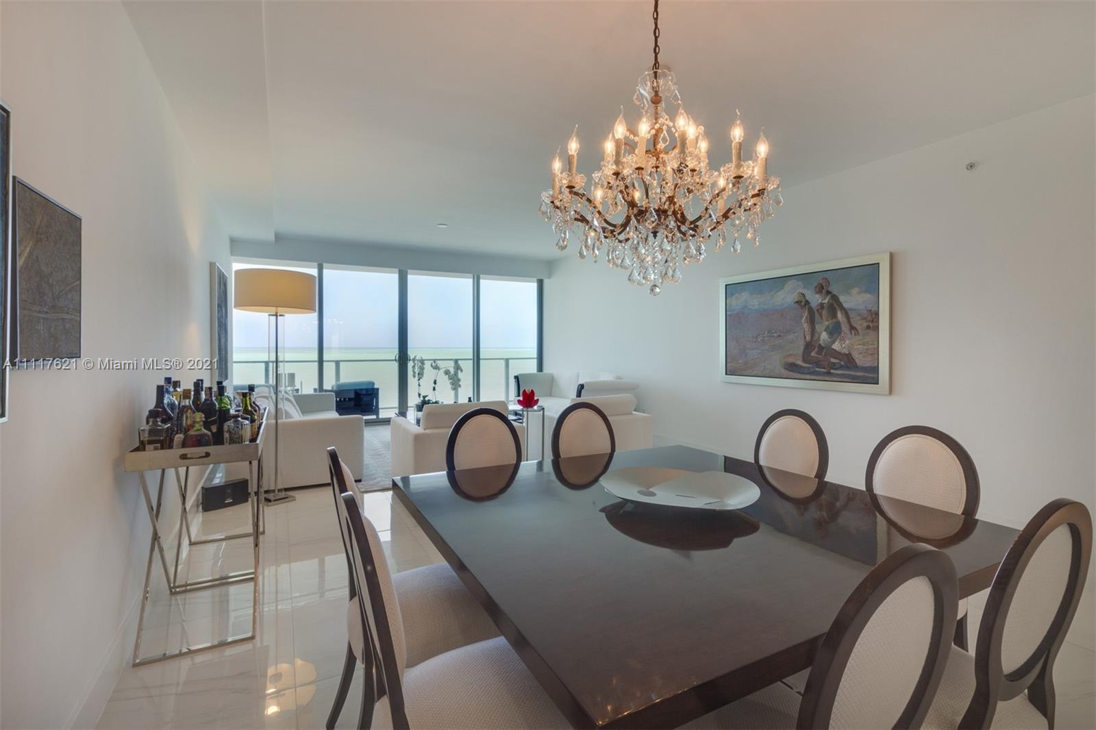 360 Ocean Drive, Unit 1106S Key Biscayne, FL 33149 - Photo 8 of 35 a dining room with furniture a chandelier and window
