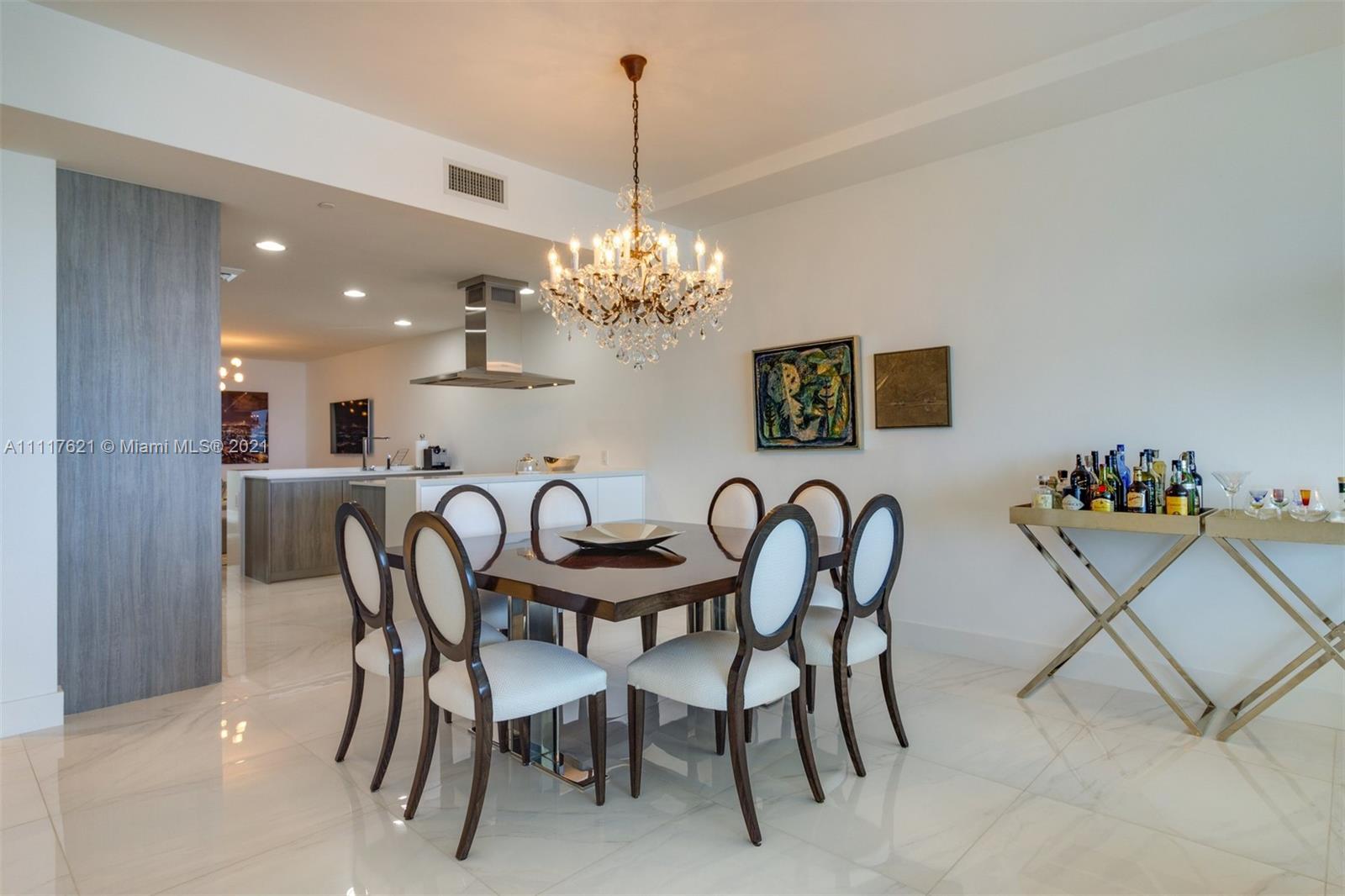 360 Ocean Drive, Unit 1106S Key Biscayne, FL 33149 - Photo 10 of 35 a dining room with furniture and chandelier