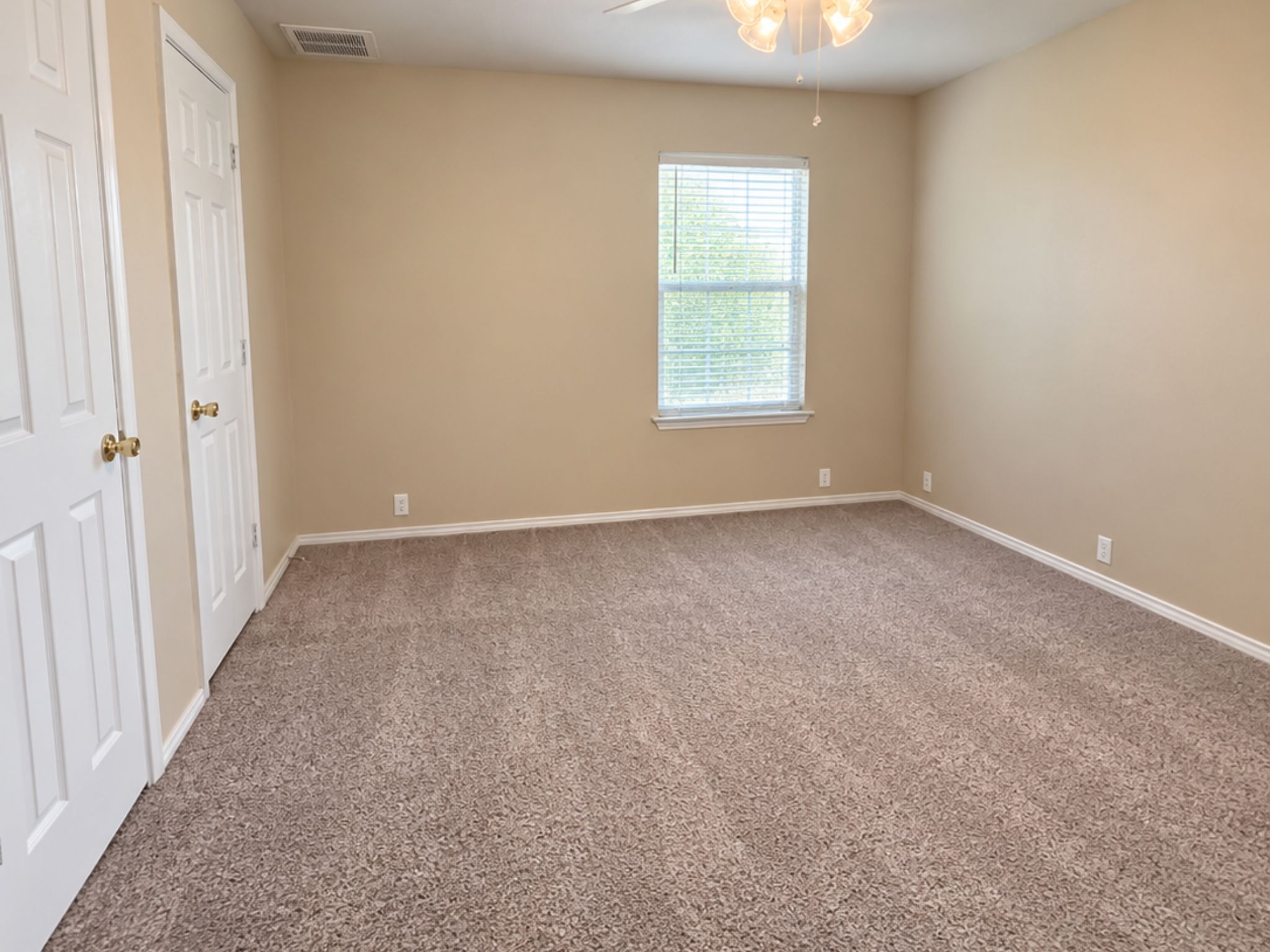 5679 Fergus, Unit B Kyle, TX 78640 - Photo 14 of 26 Soft carpeting pairs with neutral walls and classic white trim in this versatile bedroom.