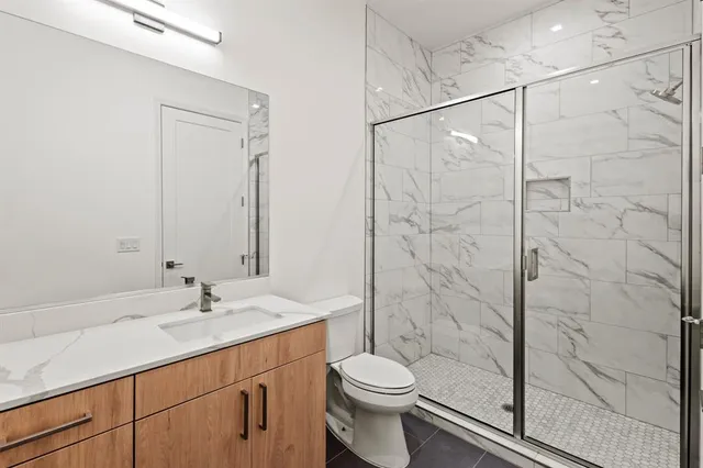 a bathroom with a sink toilet and shower