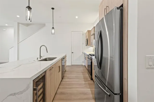 a kitchen with stainless steel appliances a sink and a refrigerator