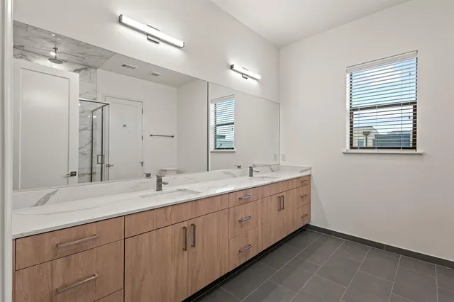a spacious bathroom with a double vanity sink mirror and double
