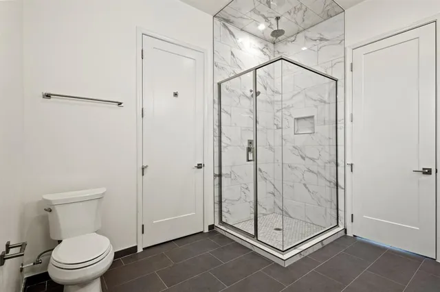 a bathroom that has a glass shower door