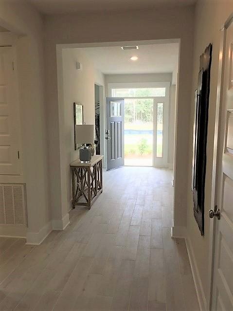 6068 Carina Road Crestview, FL 32539 - Photo 7 of 28 a view of a hallway to a livingroom with a window