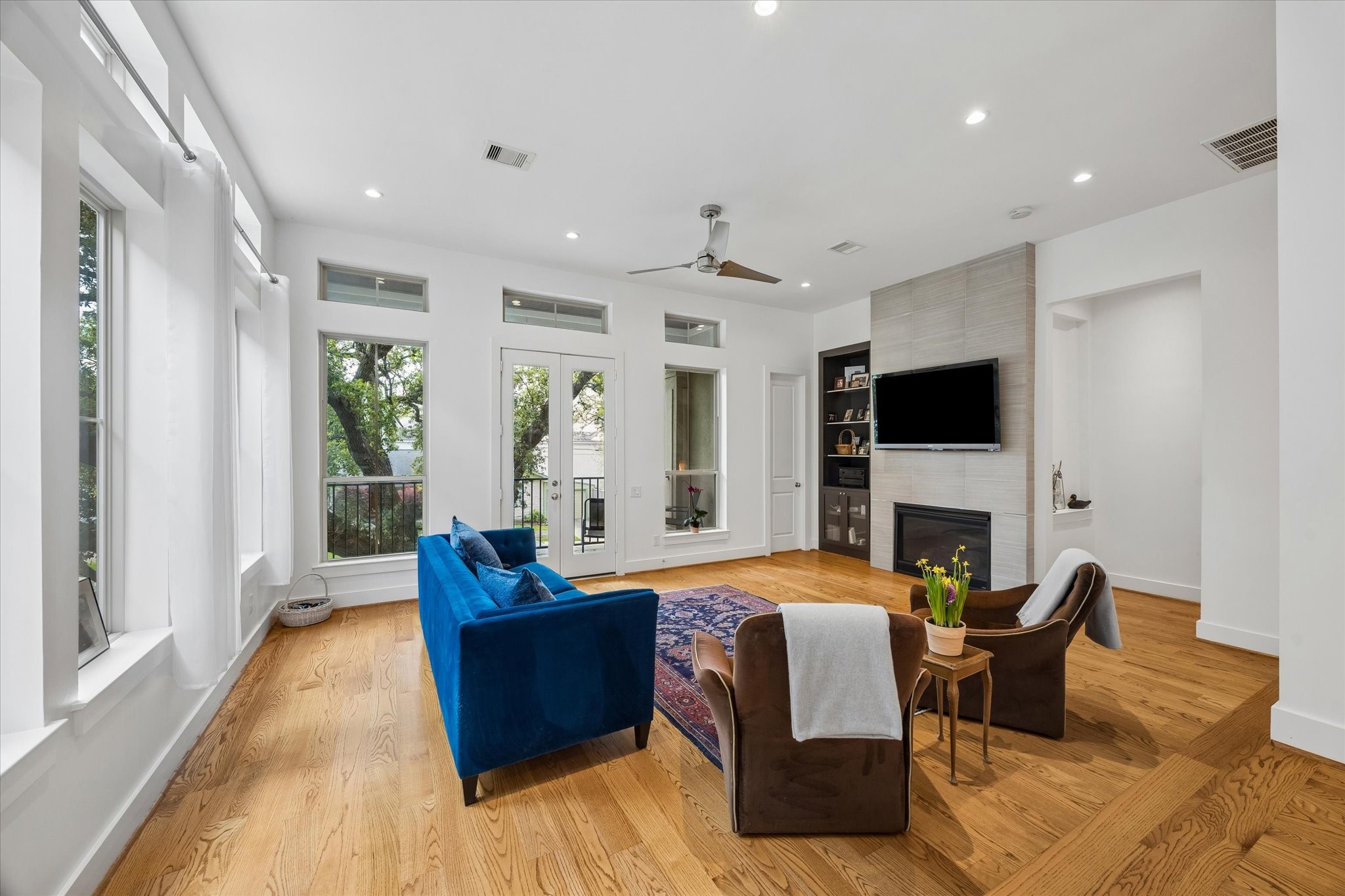 1518 West Clay Street Houston, TX 77019 - Photo 11 of 36 Sunlit family area looks toward the fireplace and patio focal points.