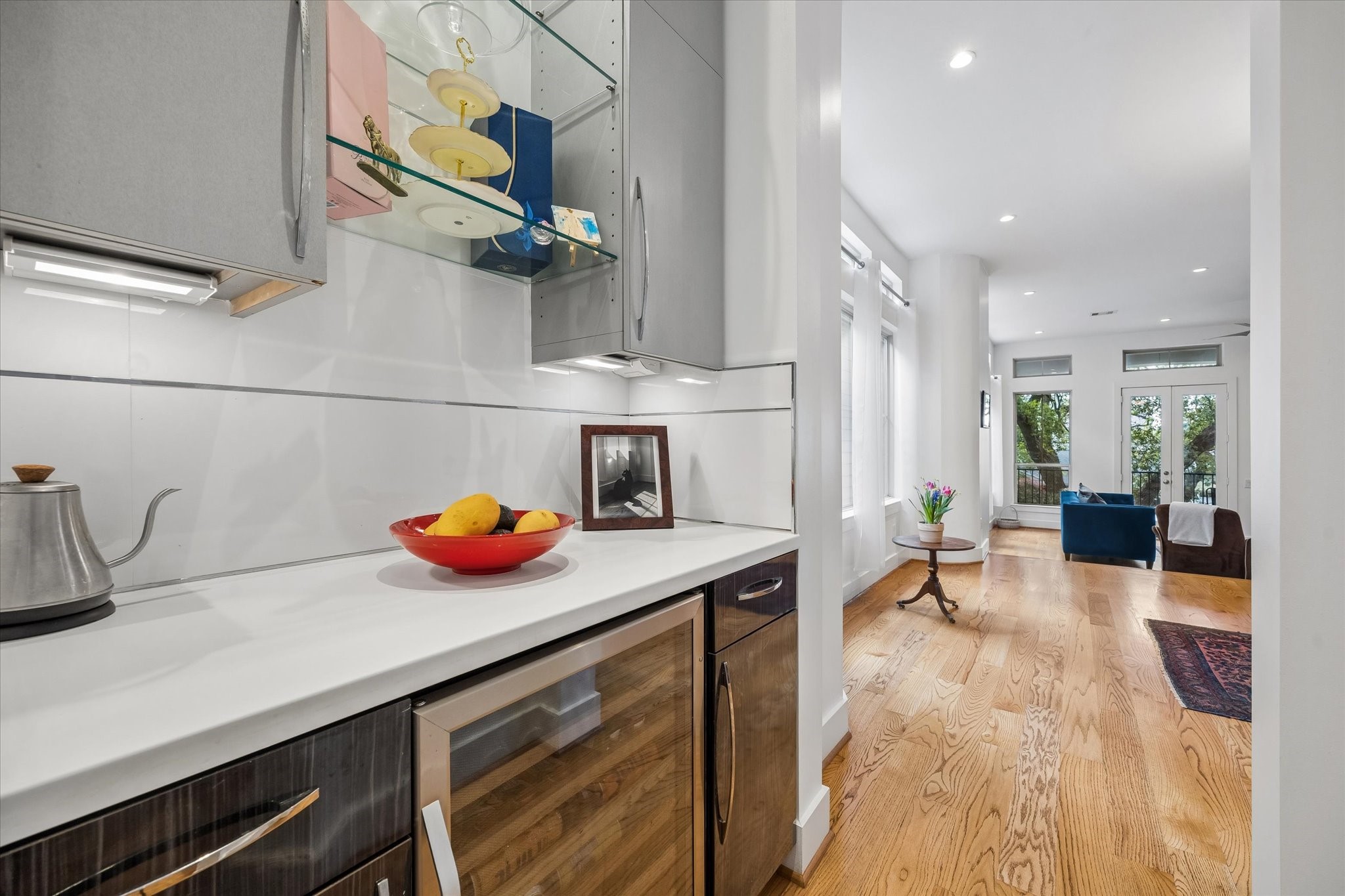 1518 West Clay Street Houston, TX 77019 - Photo 17 of 36 Butler area with beverage fridge, glass display shelving and under counter lighting.