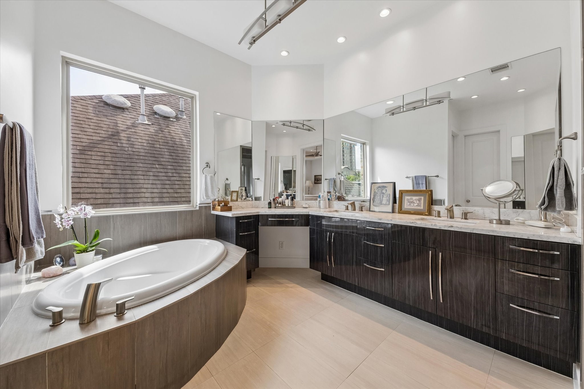1518 West Clay Street Houston, TX 77019 - Photo 20 of 36 Primary bath with soaking tub, tile floors, extensive cabinetry, and vanity area.