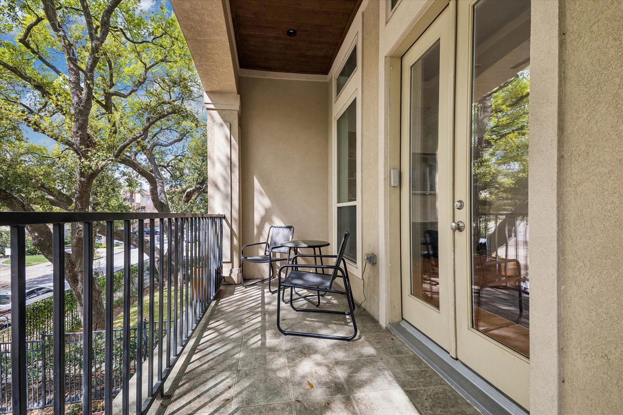 1518 West Clay Street Houston, TX 77019 - Photo 2 of 36 Above the driveway is a porch for relaxing under the shade of the oak tree and watch the world go by.