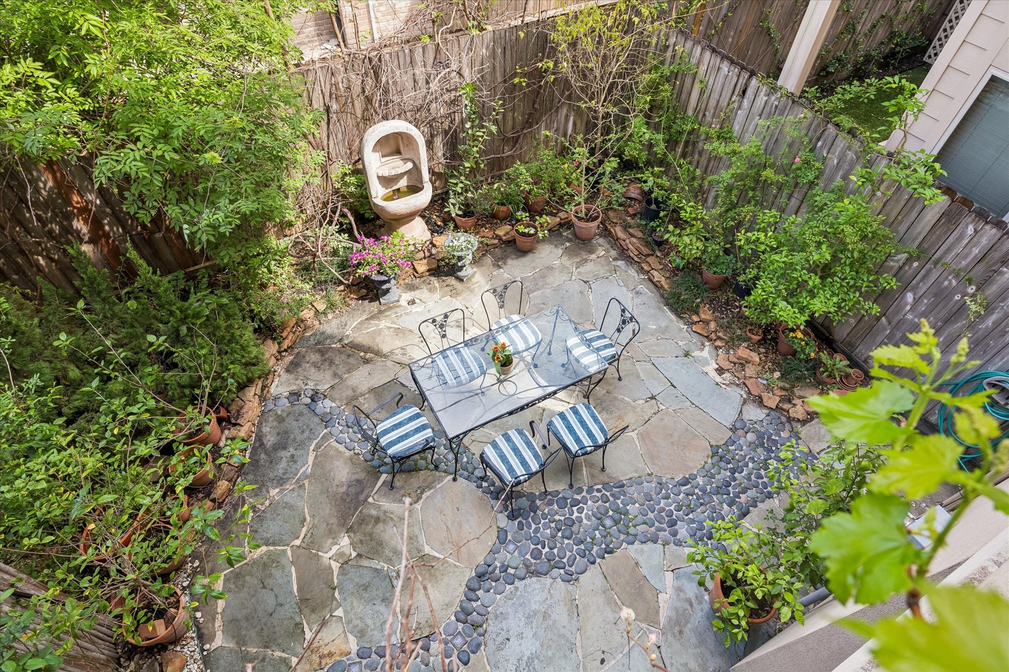 1518 West Clay Street Houston, TX 77019 - Photo 29 of 36 Overhead view into the hardscaped patio with fountain, dining and lush garden.