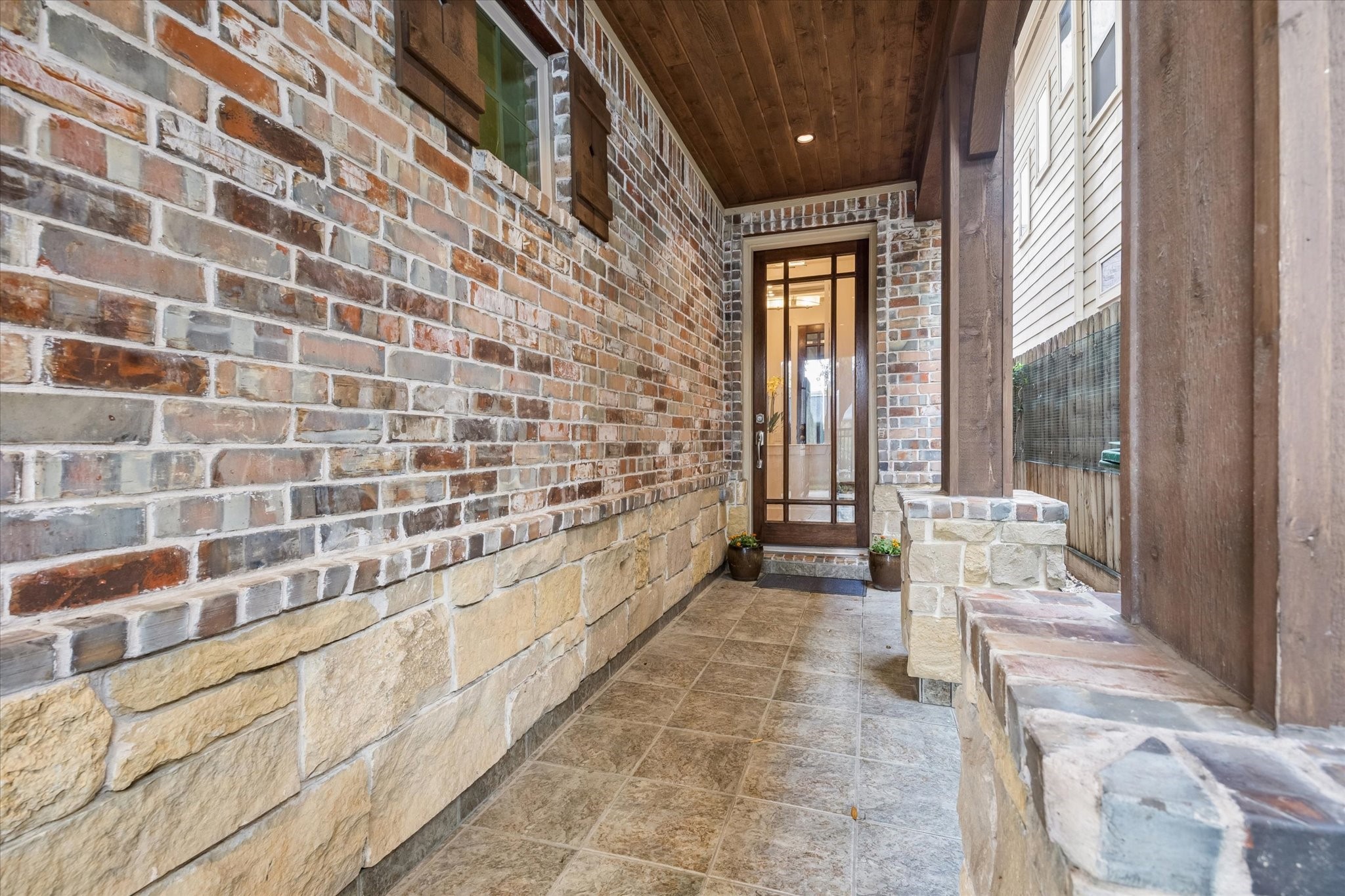 1518 West Clay Street Houston, TX 77019 - Photo 3 of 36 Stroll up the brick and stone walled entryway to the welcoming foyer.