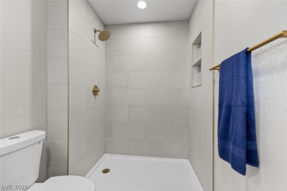 2484 Anglia Street Las Vegas, NV 89142 - Photo 12 of 20 This sleek bathroom features a modern shower with clean lines and sophisticated fixtures.