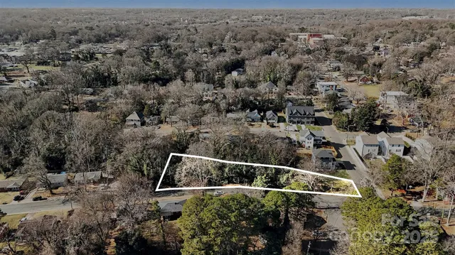 an aerial view of house with yard and mountain in the background