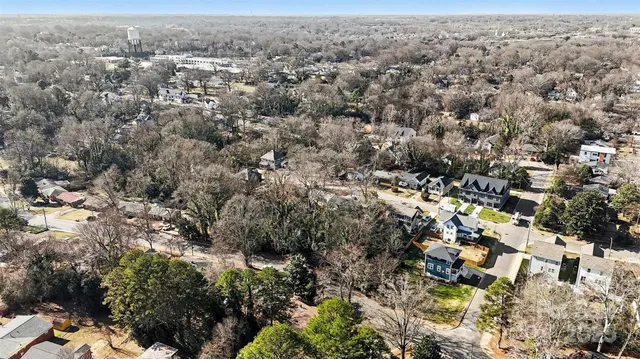 an aerial view of house with yard and mountain view in back