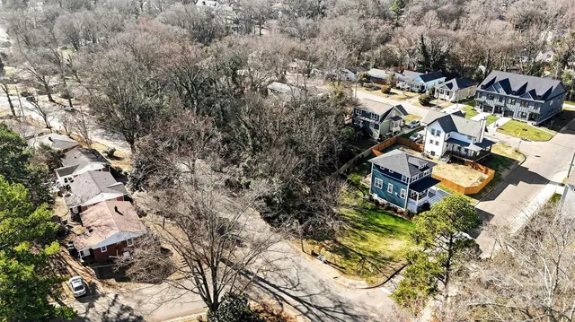 an aerial view of residential house with yard and green space