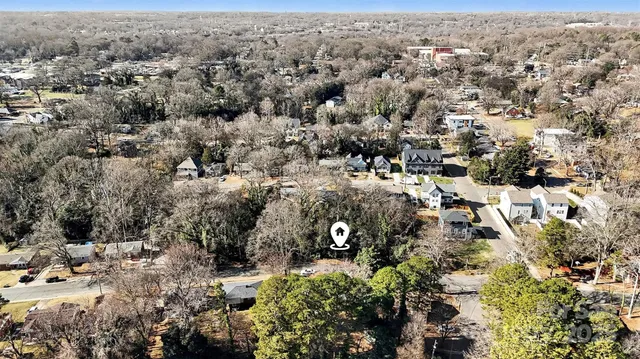 an aerial view of house with yard and mountain view in back