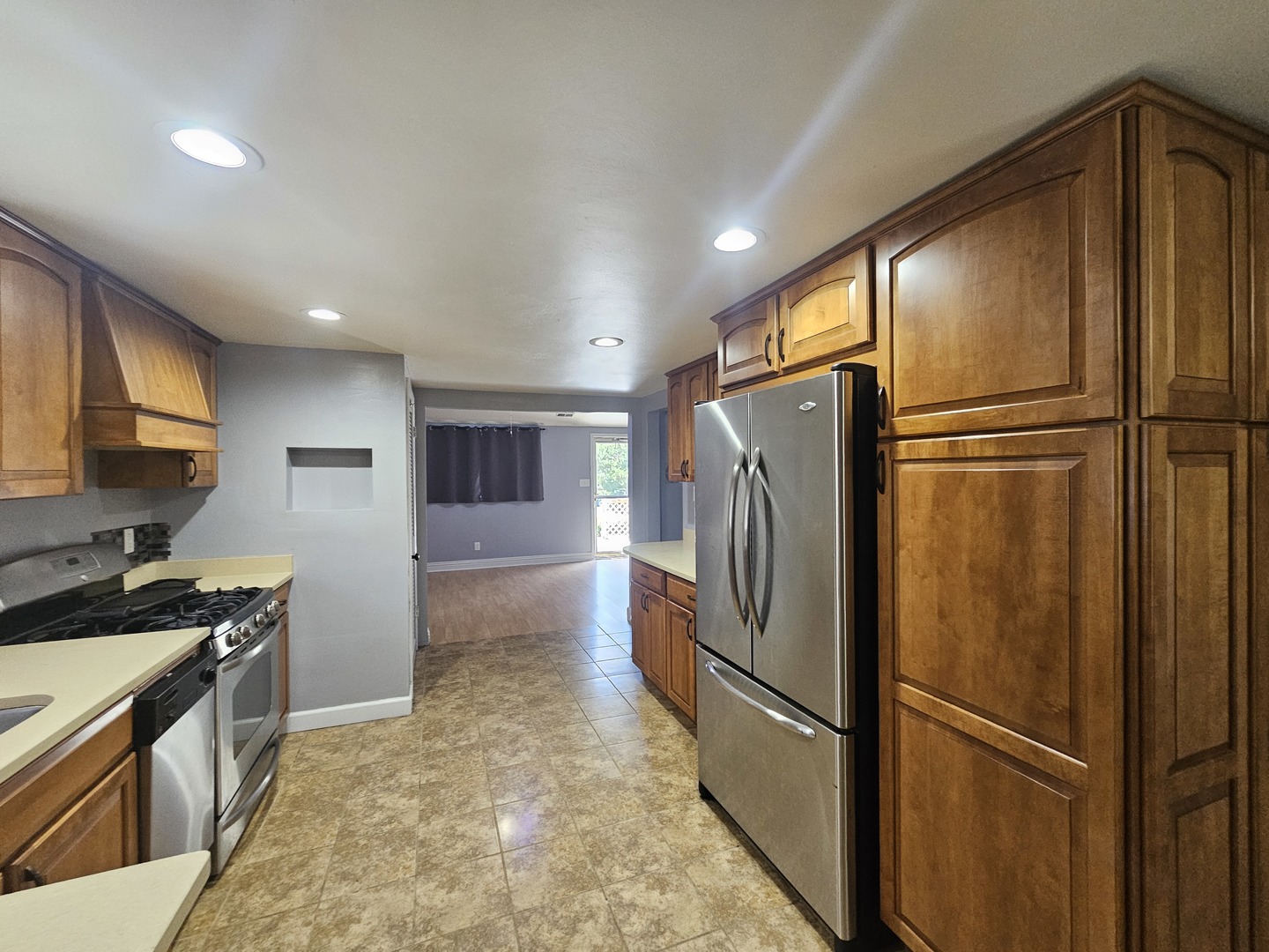 10N827 Hawthorne Street Elgin, IL 60123 - Photo 3 of 14 a kitchen with stainless steel appliances granite countertop a refrigerator and a sink