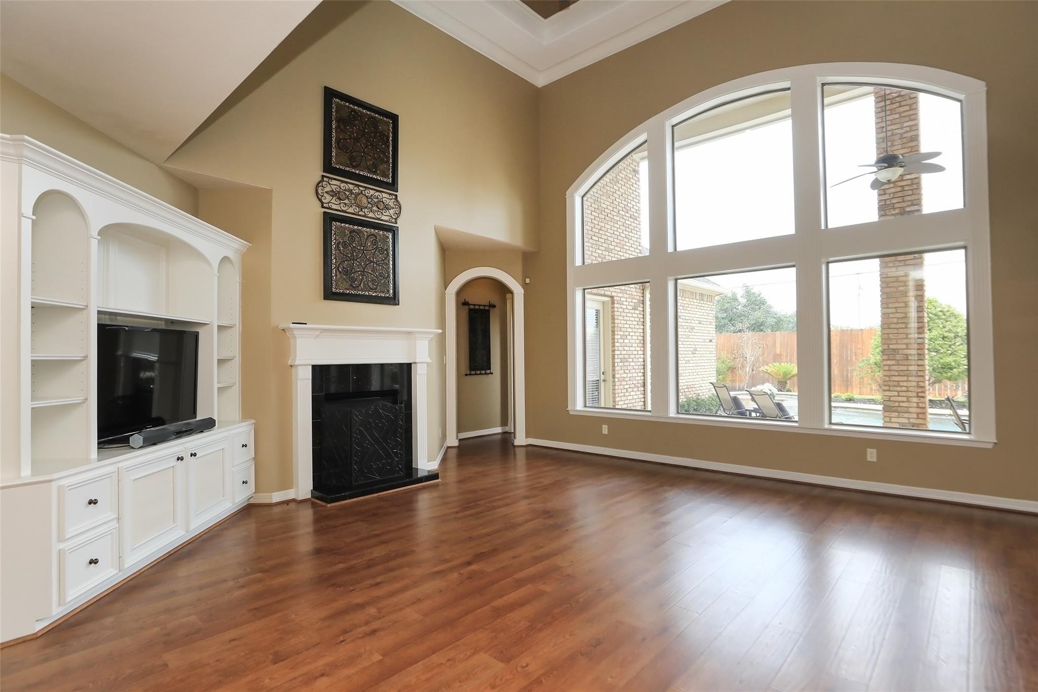 13810 Nathan Ridge Lane Cypress, TX 77429 - Photo 14 of 50 a living room with fireplace furniture flat screen tv and floor to ceiling window