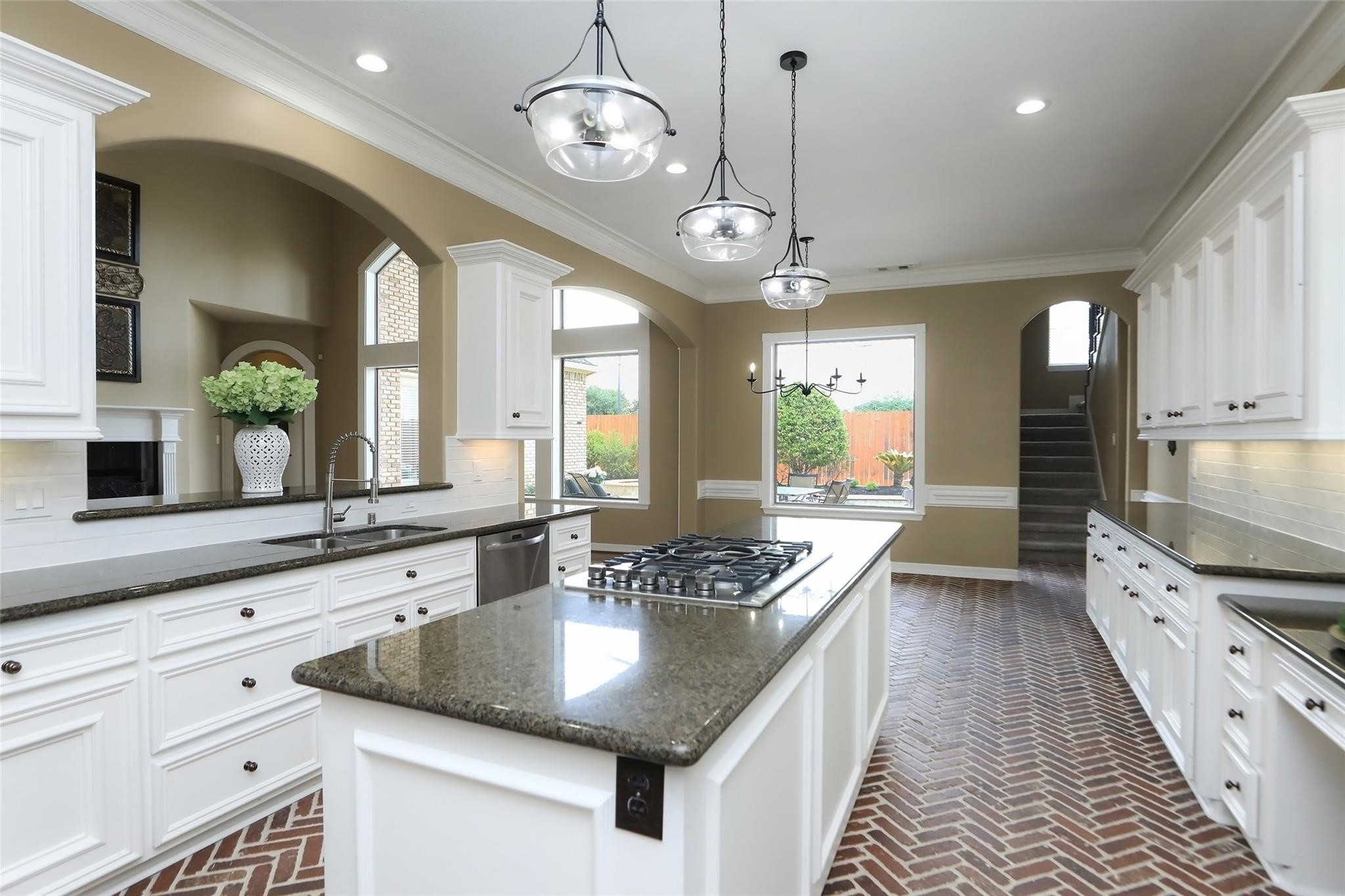13810 Nathan Ridge Lane Cypress, TX 77429 - Photo 21 of 50 a kitchen with stainless steel appliances granite countertop a sink a stove and a wooden floors