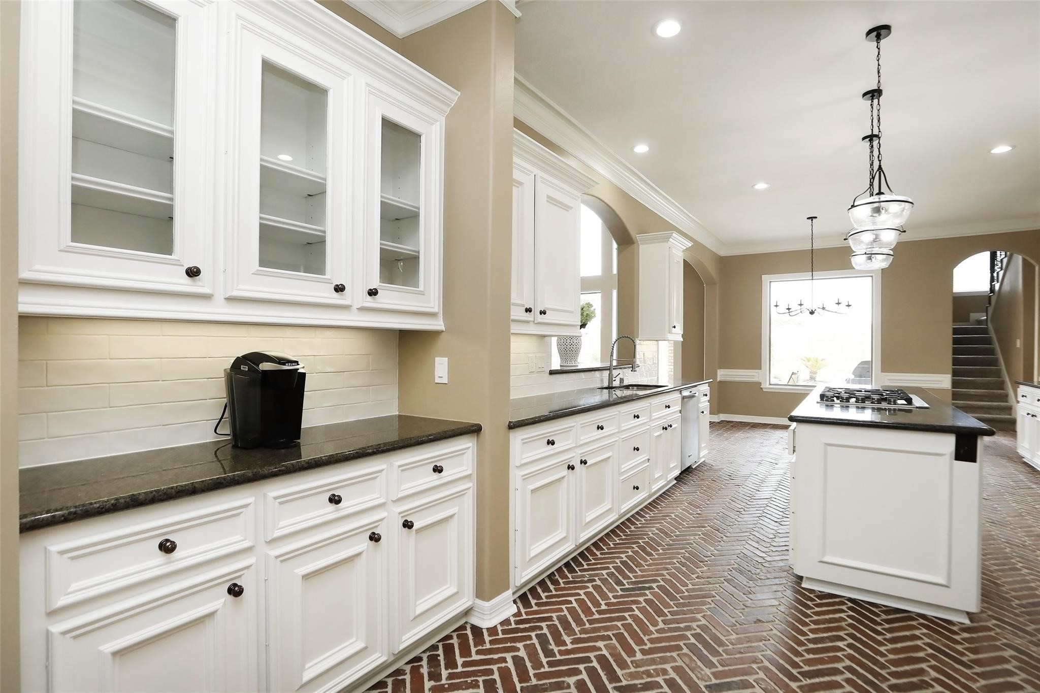 13810 Nathan Ridge Lane Cypress, TX 77429 - Photo 22 of 50 a kitchen with granite countertop a stove a sink a dining table and chairs
