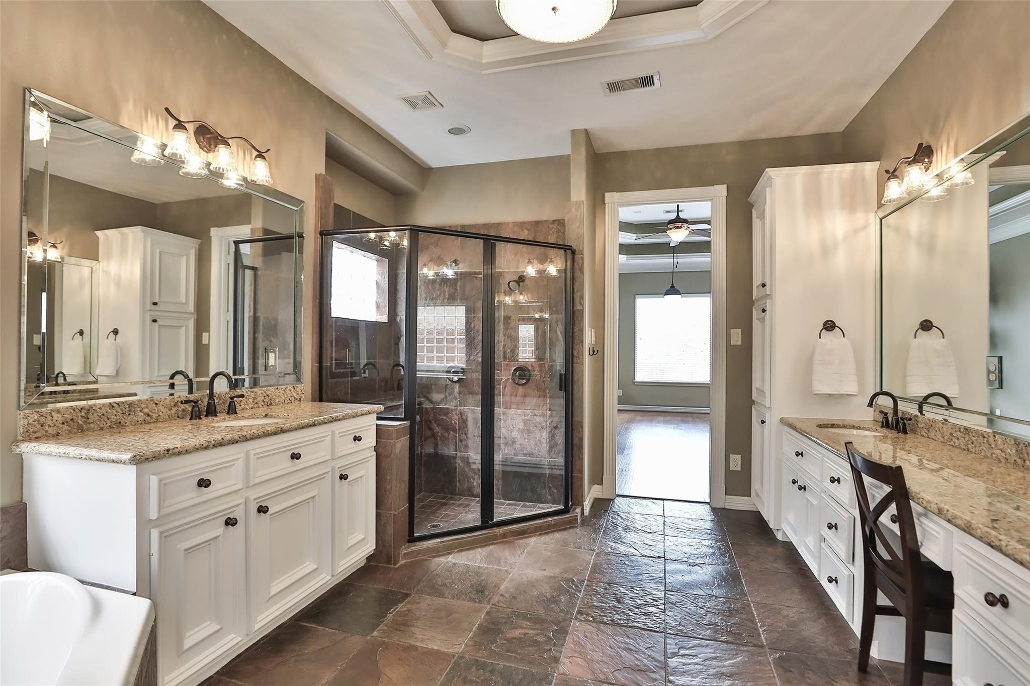 13810 Nathan Ridge Lane Cypress, TX 77429 - Photo 29 of 50 a spacious bathroom with a granite countertop sink mirror and a shower