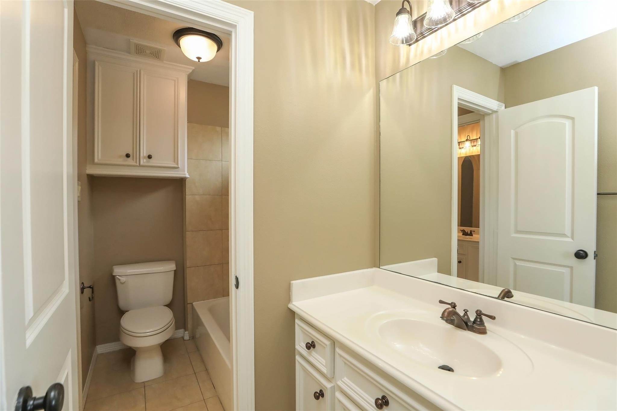 13810 Nathan Ridge Lane Cypress, TX 77429 - Photo 45 of 50 a bathroom with a toilet a sink and mirror