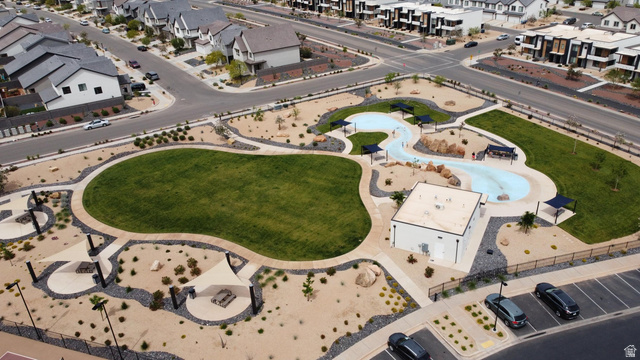 1693 Devils Gdn Lane Washington, UT 84780 - Photo 51 of 64 Expansive community park featuring a large green space, winding pool, shade structures, and surrounding desert landscaping
