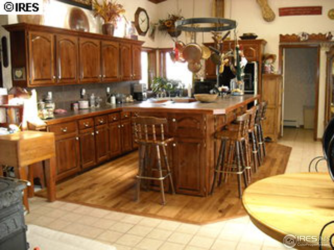 181 Chapman Road Boulder, CO 80302 - Photo 3 of 10 a view of a kitchen with kitchen island granite countertop a sink a stove a dining table and chairs