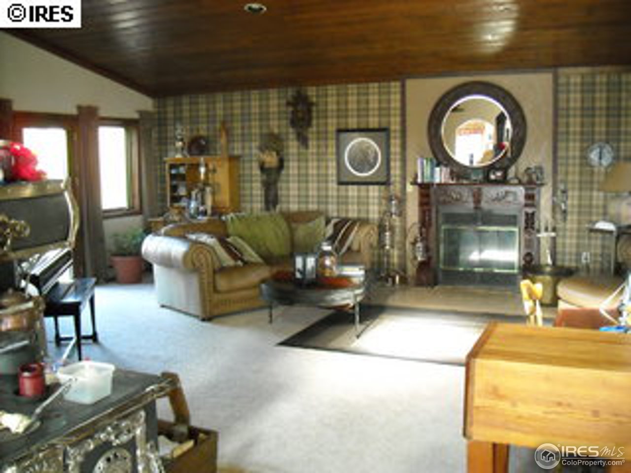 181 Chapman Road Boulder, CO 80302 - Photo 5 of 10 a living room with furniture a fireplace and a floor to ceiling window