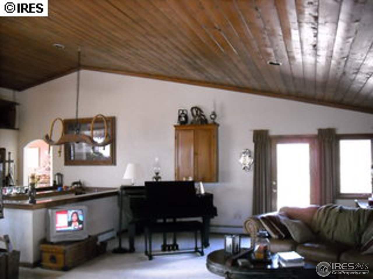 181 Chapman Road Boulder, CO 80302 - Photo 8 of 10 a living room with furniture a piano and a flat screen tv