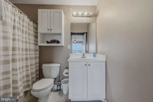 a bathroom with a toilet a sink and a mirror