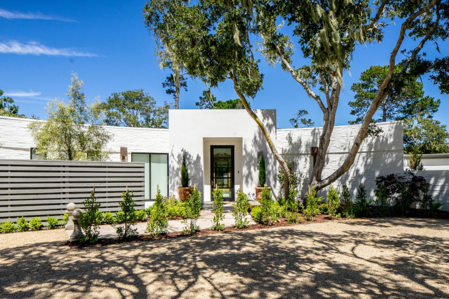 a view of a house with a tree in front