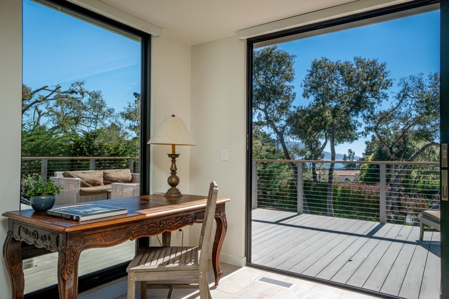 1505 Venadero Road Pebble Beach, CA 93953 - Photo 12 of 36 a view of a patio with a table chairs and a potted plant
