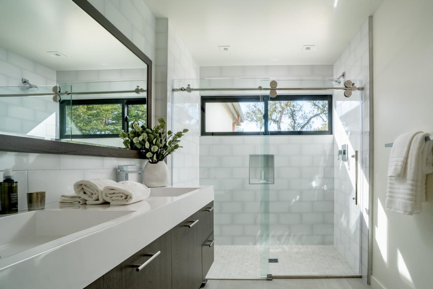 1505 Venadero Road Pebble Beach, CA 93953 - Photo 15 of 36 a bathroom with a shower sink and mirror
