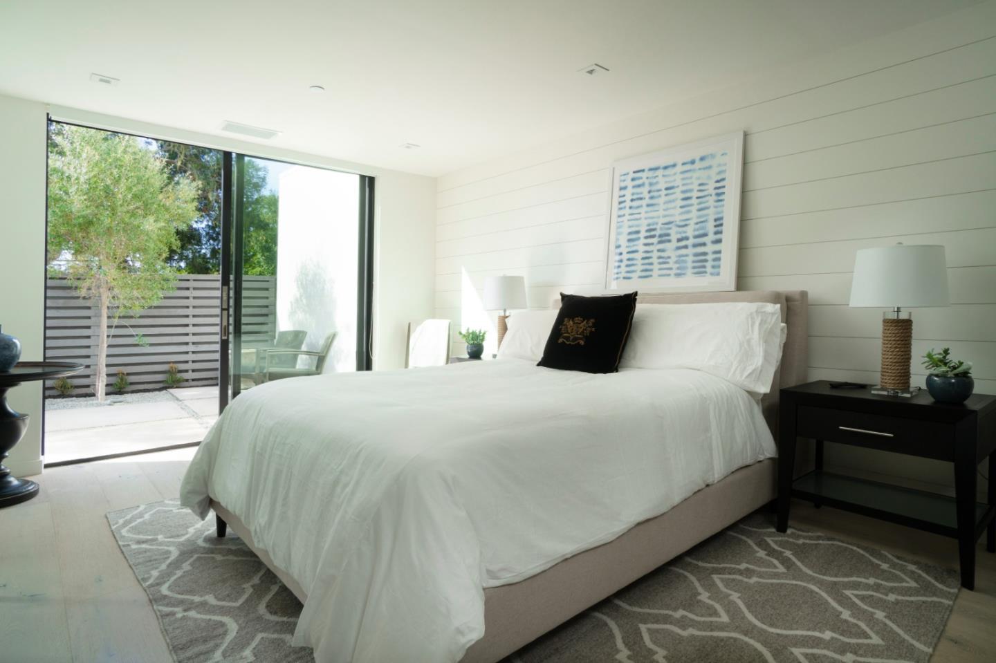 1505 Venadero Road Pebble Beach, CA 93953 - Photo 16 of 36 a bedroom with a bed and wooden floor