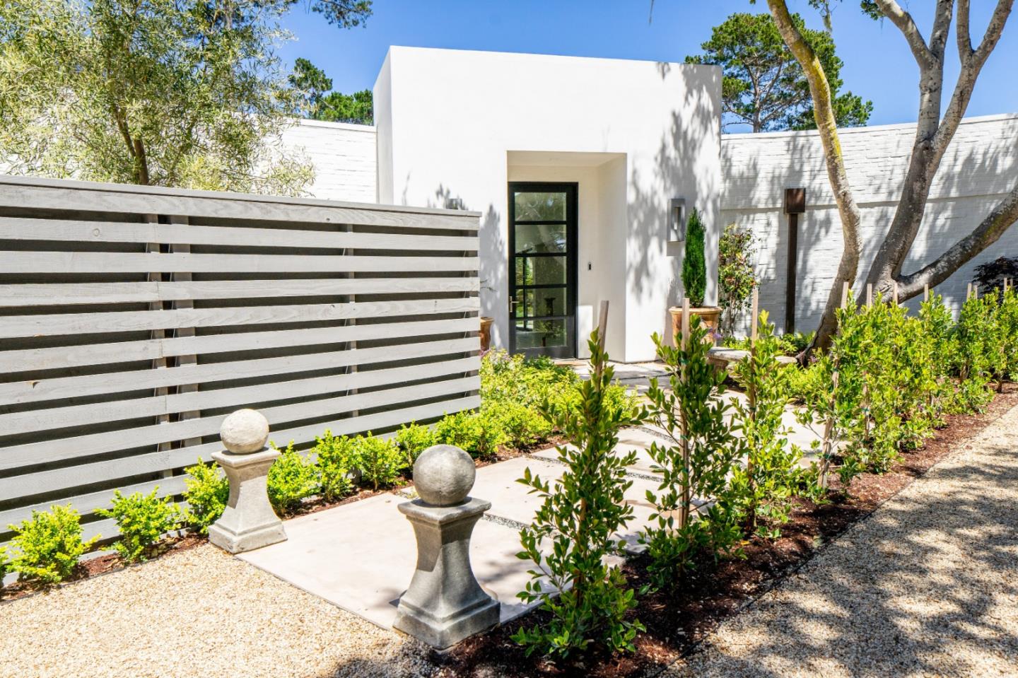 1505 Venadero Road Pebble Beach, CA 93953 - Photo 2 of 36 a wooden bench sitting in front of a house